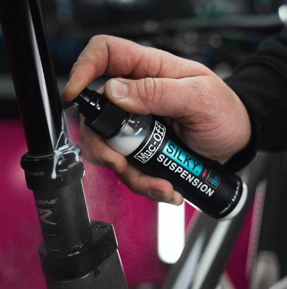 Muc-Off Silky Suspension Serum 100ml being used on a bicycle